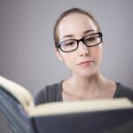 A woman reading a book. How to read more boosl.