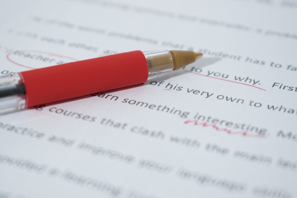 Proofreading with a red pen.